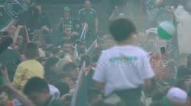 Thousands of Celtic fans celebrate outside stadium after winning league