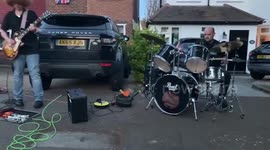 Police officer filmed playing an impromptu drum set at a coronation street party