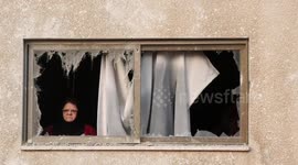 Palestinians inspect damaged buildings after Israeli air raids on Gaza City