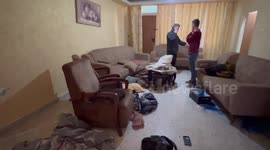Palestinians inspect a home in the aftermath of an Israeli military raid, in the West Bank city of Nablus