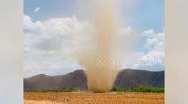 Spectacular twister rotates on field kicking up clouds of dust in Thailand