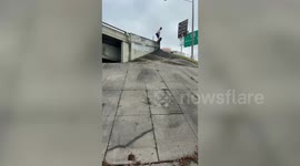 Skater slams while dropping in from bridge in Michigan