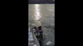Ice winter dip in the freezing icy harbour in Stockholm in the winter below freezing into the ice on a sunny day