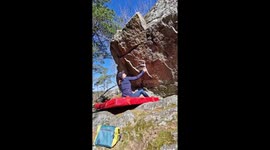 Woman outdoor bouldering on a sunny day in Sweden near Stockholm