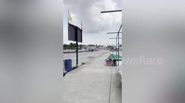 Tent flies into the sky as storm blows through market in eastern Thailand