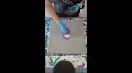 Artist reveals her amazing pouring technique to create perfect purple flower artwork