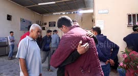 Relatives mourn outside the morgue of a hospital in Beit Lahia