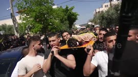 Mourners carry the bodies of two Palestinians during their funeral in the West Bank city of Jenin