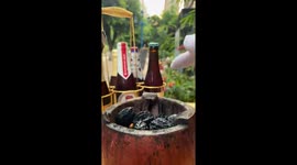 Traditional Chinese cuisine: cooking and enjoying pig's brain in an iron cup