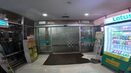 Street light flickers as powerful storm leaves shoppers stranded in mall in central Thailand