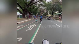 Cute toddler rides tiny bicycle next to father