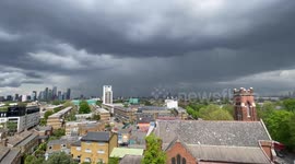 Dark storm clouds loom over central London's skyline as yellow warning issued