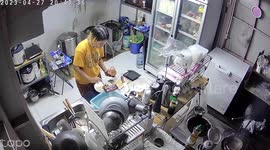 Super-calm cook casually carries burning pan out of kitchen