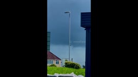Funnel cloud forming captured by weather enthusiast whilst waiting for her breakfast roll