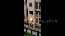 Retired soldier climbs block of flats to extinguish kitchen fire in southern China