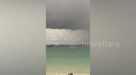 Double waterspout tornado forms off the coast of southern Thailand