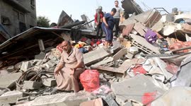 Palestinian family searches through rubble of house destroyed by Israeli airstrike