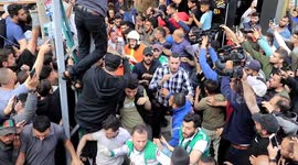 Evacuation of wounded Palestinians from a building following an Israeli air strike