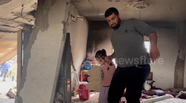 Palestinians inspect the damaged building in the aftermath of Israeli warplanes airstrikes in Deir al-Balah, central Gaza Strip.