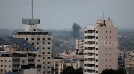 A plume of smoke rises above buildings in Gaza City during an israeli air strike