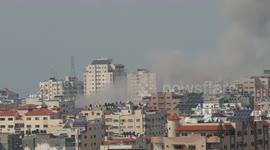 A plume of smoke rises above buildings in Gaza City during an israeli air strike