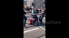 Australian police pin protesters to ground during clashes on new immigration laws