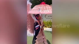 Sixth-grader wears angel wings made of banknotes to celebrate graduation