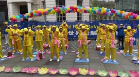 Practitioners in colourful clothing celebrate World Falun Dafa Day in London