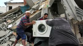 Palestinians inspect the damaged building in the aftermath of Israeli warplanes airstrikes in Gaza city.
