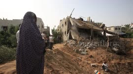 Palestinians inspect their homes after Israeli attack in Gaza