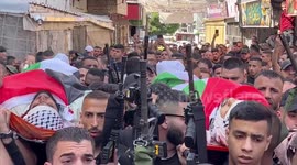 Palestinians take part in the funeral procession of Saed Masheh, 32, and Wassim Al-Araj, 19, who died earlier during an Israeli army raid, at the Balata refugee camp in the West Bank