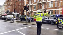 A Uniformed Police Officer Direct Traffic While A Diplomat Convoy Escorted By The Met Special Escort Group Returns To Kensington Palace Gardens