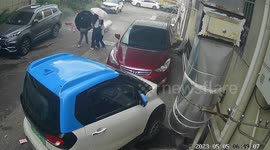 Solar water heater narrowly misses pedestrians after falling from building in China
