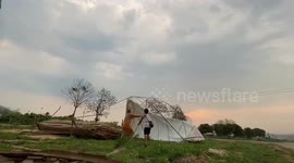 Villagers battle to anchor tent during storm in Thailand