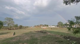 Beautiful Nature Rainbow In The Sky in India .wonderful rainbow with a village green field and wonderful sky