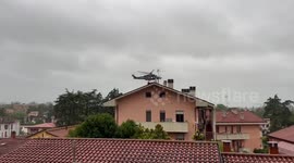 Emergency aircraft rescues people stranded on flooded building roofs in Italy