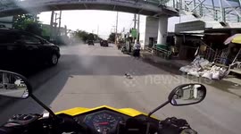 Kind motorcycle rider stops and picks up lost puppy on edge of road