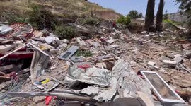 Palestinians collect thier belongs during demolition commissioned by Israel
