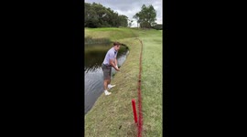 Man is forced to take a swim after his risky golf shot backfires big time!