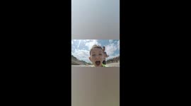 My son and I jumping in waves on the beach on Majorca