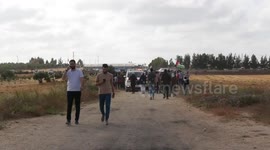 Protesters gather during a Palestinian 'flag march' demonstration along the border with Israel east of Gaza city in response to the annual Israeli flag march marking 'Jerusalem Day' commemorating the old city's capture by Israel