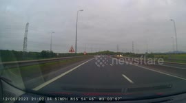 Car overtakes at high speed with lots of smoke leaving a trail behind it, on driving lesson