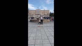 Funny happy Asian couple dancing tango in the center of Athens, Greece