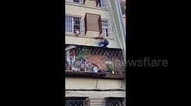 Heroic man rescues toddler hanging from third-floor window in China