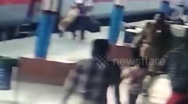 Female passenger slips while getting down moving train in northern India, cop comes to her rescue
