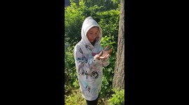 Girl playing with great tit after their first flight lessons