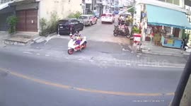 Car bumps into motorcycle rider while reversing out of driveway