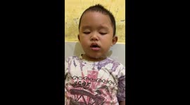 A little boy (2 years old) could not help falling asleep while he was eating his lunch