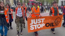 Protesters from Just Stop Oil slow walk around Parliament Square blocking roads London England UK