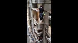 Brave man climbs high-rise building to save crying cat